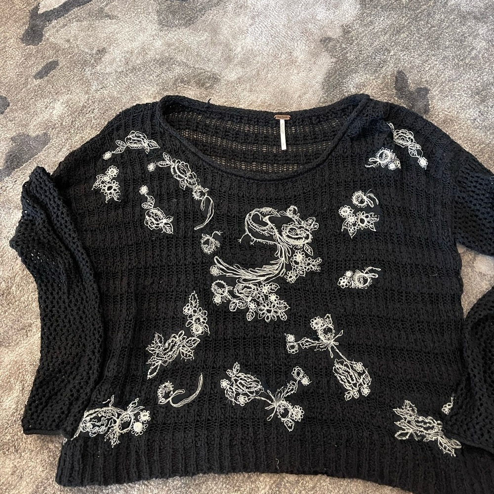 Beautiful crochet stitched black knit sweater with cream stitched flowers.